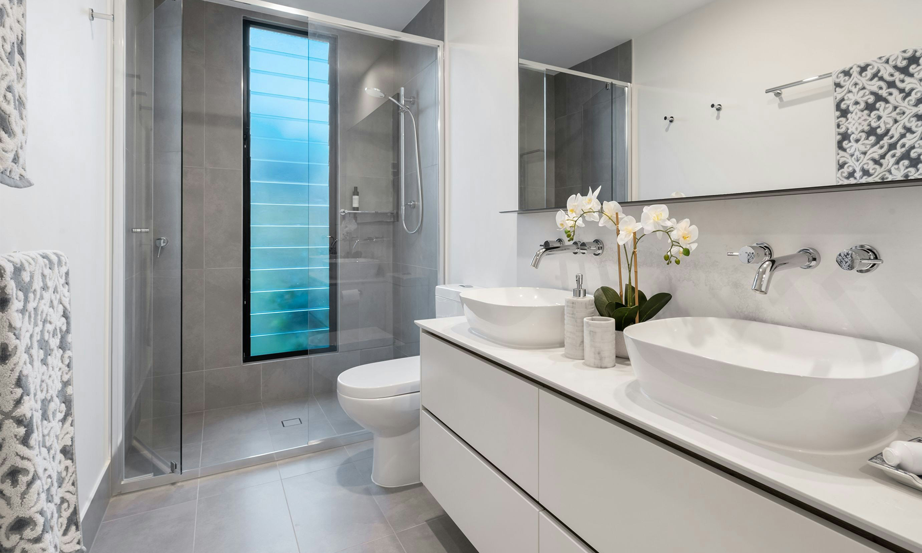 Spacious open concept bathroom with floating vanity and vessel sink